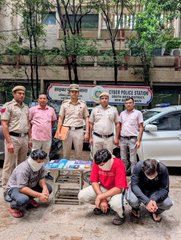 Delhi Police stand with four arrested individuals accused of a ₹12 Lakh scam involving fake work-from-home offers on Telegram that funneled money to China. The image directly illustrates the arrests mentioned in the accompanying text.