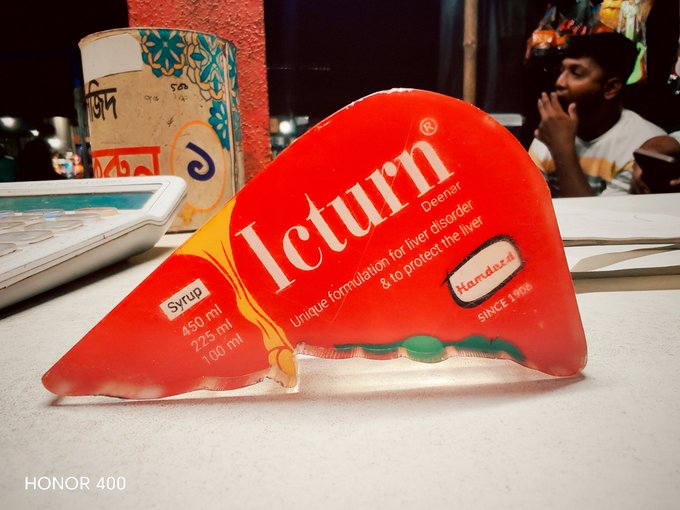 A red liver-shaped promotional display for 'leturn' liver disorder syrup (450ml/225ml/100ml) by Hamdard, photographed with an HONOR 400 watermark.