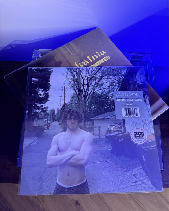 A vinyl record album cover for Jack Harlow's single 'First Class' on 75Q Records, showing a shirtless young man standing in an alleyway, lit with blue light.