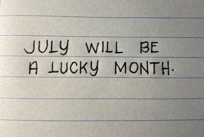 A handwritten note on lined paper reads "JULY WILL BE A LUCKY MONTH." The optimistic message aligns with the post's call to engage with a "gm" (good morning) giveaway, reinforcing the hopeful, positive tone around the $SOL prize opportunity.