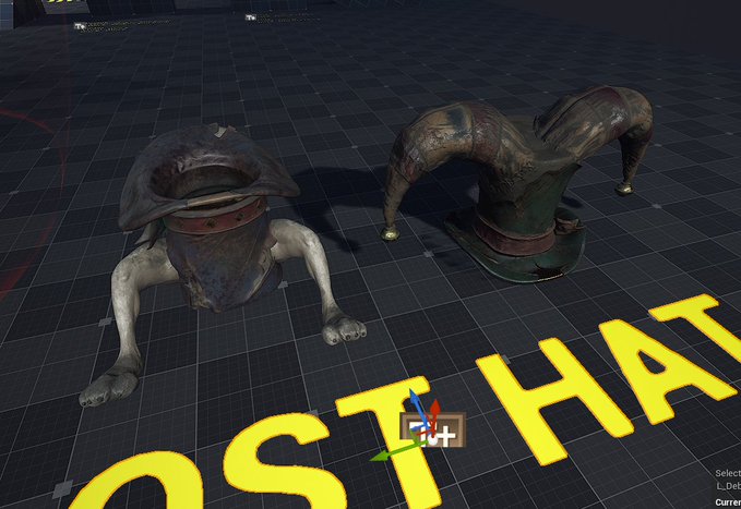 Two distorted, worn hats with arms and legs sit on a grid floor in a game engine, with the text 'LOST HAT' visible below.