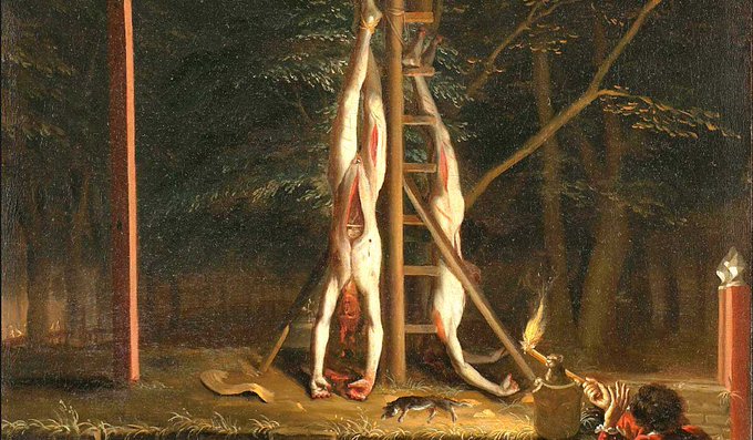 The image depicts two figures with flayed skin hanging upside down from a wooden structure in a dark forest, illuminated by a torch held by a person in the foreground; this macabre scene ironically relates to the accompanying text about a "prime minister waiting til the last minute" to buy @BitcoinConfEUR tickets.