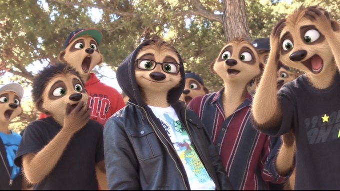An image showing several people wearing animated meerkat-style cartoon face filters, with exaggerated large eyes and furry features, appearing shocked or surprised in an outdoor setting.
