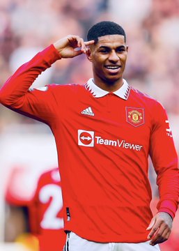 Marcus Rashford, wearing Manchester United's red home kit featuring the "TeamViewer" sponsor logo, performs his signature salute after scoring. The image accompanies news that his £40 million release clause has expired, meaning any potential transfer would now require direct negotiations between clubs rather than the player triggering a fixed-price move.