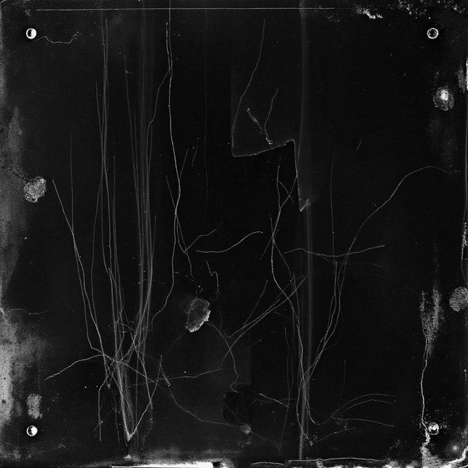 The image shows a black and white photograph of a window with a crack running through it, which appears to be damaged or broken. The photo has been edited to appear as if it was taken at night, giving it an atmospheric feel. The background is dark, emphasizing the stark contrast between the cracked window and its surroundings. The caption below the image reads "Garden 1/1 XTZ objkt.com/tokens/KT1WQsz".