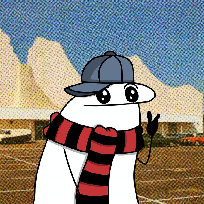 A cartoon illustration shows a white blob-like character wearing a backwards blue cap and a red and black striped scarf, standing in a parking lot.