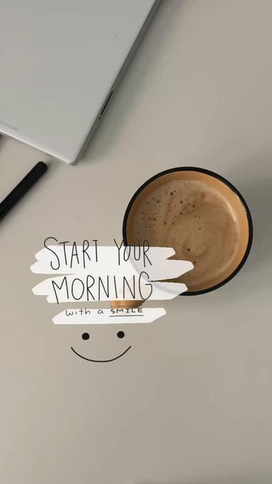 A flat lay photograph shows a coffee mug on a white surface next to a laptop, with overlaid text reading "START YOUR MORNING with a SMILE" and a smiley face drawing.
