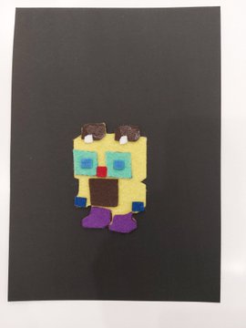 A small pixel-art SpongeBob SquarePants figure made of perler beads displayed on a black background.