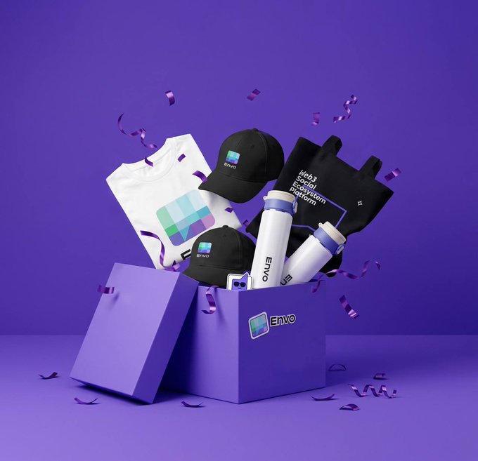 A 3D promotional render of a purple gift box branded "Envo" containing merchandise including t-shirts, caps, water bottles, and a tote bag, with confetti floating around.