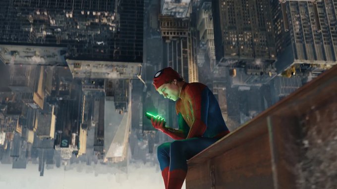 Spider-Man sits perched on a ledge high above a city skyline, looking down at a glowing device in his hands.