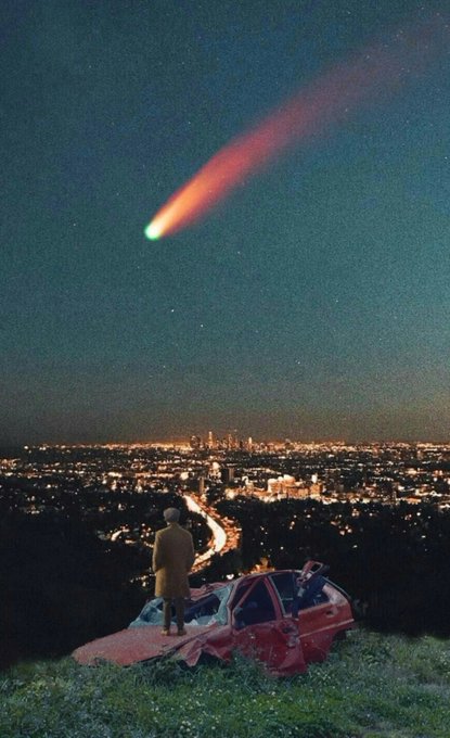 A person stands atop a wrecked red car on a hill overlooking a glowing cityscape at night, gazing up as a brilliant comet streaks across the sky with a long, fiery tail. The surreal, dreamlike collage blends cinematic photography with fantastical elements to evoke a sense of awe and longing—mirroring the wistful, contemplative mood suggested by the "King of Wishful Thinking" title.