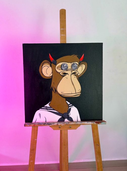 A painting on a wooden easel depicts a Bored Ape-style monkey wearing a sailor outfit with a black neckerchief, set against a dark background with pink lighting on the left.