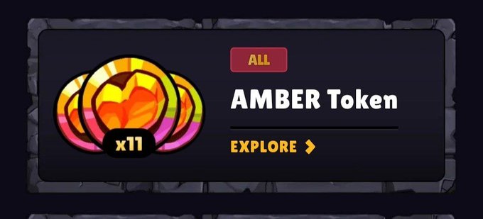 A dark-themed UI panel displaying 'AMBER Token' with an 'ALL' badge, an 'EXPLORE' button, and a colorful flower-like token icon marked 'x11'.