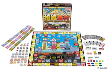 The image shows the board game "Toshi Banzuke" with its box, game board featuring city and investment-themed squares, colorful player tokens, play money, and various cards. The components reflect the game's premise of building wealth through gold, stocks, and cryptocurrencies while navigating economic setbacks like the Great Depression.