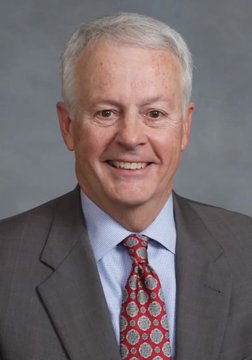 A professional headshot of an older gentleman with white hair, wearing a gray suit, light blue shirt, and red patterned tie, smiling at the camera. The image relates to the post as it appears to depict Rep. Hugh Blackwell, who is mentioned as stating that the $30 TRILLION CLARITY Act is a "done deal," with the caption emphasizing the potential impact on XRP and digital assets.
