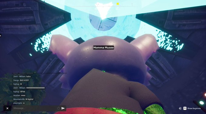 A first-person view from a video game showing a character's arm labeled "Momma Musee" beneath a glowing blue structure, with a live chat on the left displaying usernames like ZerX, Dangu, and hotpop.