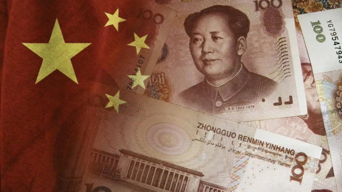 Chinese 100 yuan banknotes overlaid with the Chinese national flag featuring Mao Zedong's portrait.