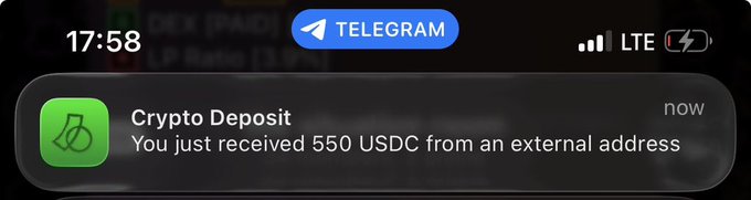 An iOS notification from Telegram showing a 'Crypto Deposit' alert stating 'You just received 550 USDC from an external address' on the lock screen at 17:58.