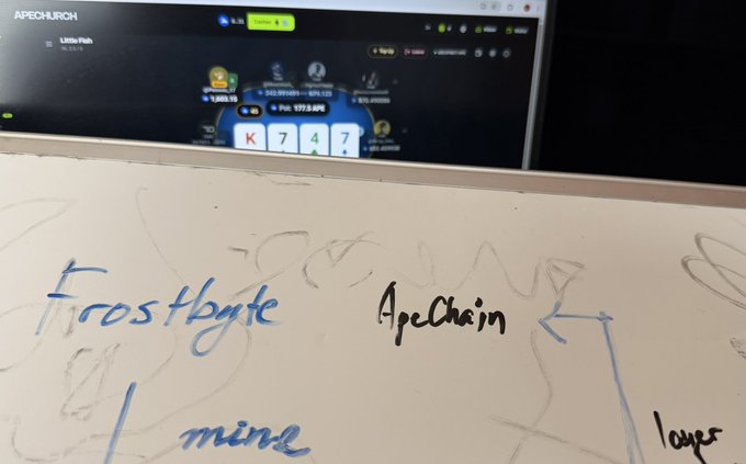 A whiteboard with handwritten notes 'Frostbyte', 'Apechain', and 'mine' visible, with a computer screen in the background showing 'APECURCH' website.