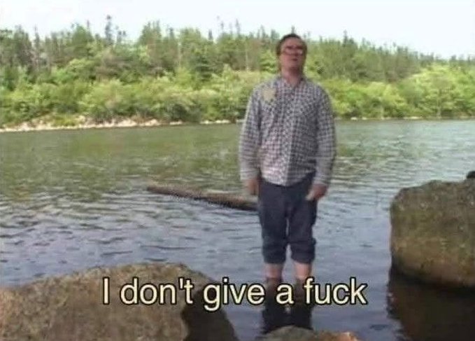 A man stands confidently in a river wearing a plaid shirt and rolled-up pants, with the caption "I don't give a fuck" overlaid in white text—matching the post's theme of unapologetic indifference to low engagement on a social media post.