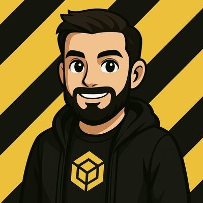 A cartoon-style avatar of a smiling, bearded man wearing a black hoodie featuring a yellow 3D cube logo—representing the BNB Chain—against a black and yellow striped background. The image visually corresponds to the post's tribute, which credits the person as a long-time mentor and community legend who introduced the author to crypto and the BNB Chain ecosystem, with the "$AB" ticker referenced in the caption.