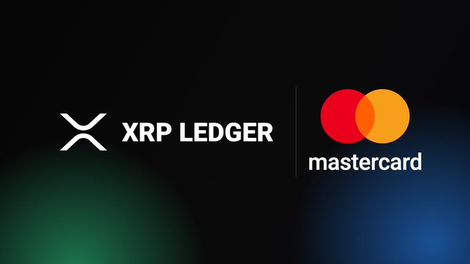 The image features a black background with two logos - one representing Mastercard and the other representing XRP Ledger. The Mastercard logo has a red circle, while the XRP Ledger logo displays an orange circle. Both logos are positioned on the same side of the image, creating a balanced visual effect. The text "Yes." is written in white at the bottom right corner of the image.