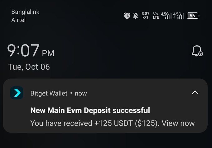 A phone lock screen showing 9:07 PM on Tue, Oct 06, displaying a Bitget Wallet notification: 'New Main Evm Deposit successful - You have received +125 USDT ($125).' with Banglalink and Airtel carrier signals.