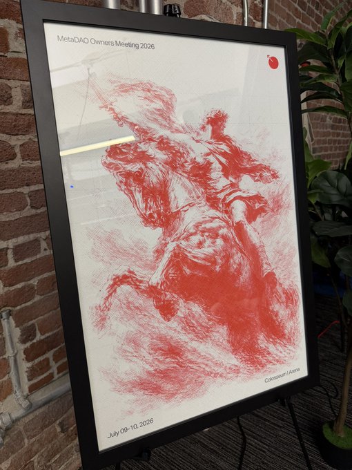 A digital display for the 'MetaDAO Owners Meeting 2026' showing a red sketch of a rearing horse labeled 'Colosseum / Arena' with the dates July 09-10, 2026, beside a potted plant.