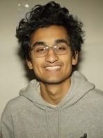 A young man with glasses and a gray hoodie smiles in a portrait-style photo, likely representing the trader referenced in the post. The image accompanies a breaking news announcement about FrankDeGods' significant profits from holding a "moonbag" of $PAID tokens, which grew from $12M to $33M in market cap.