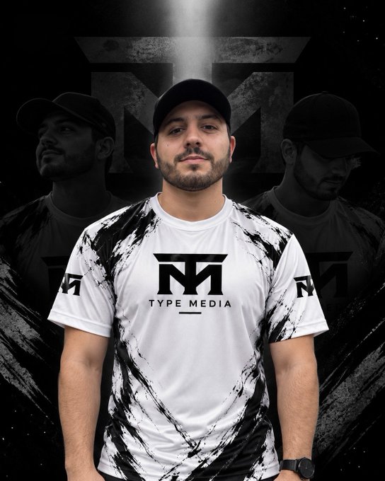 A man wears a white and black marbled 'TYPE MEDIA' t-shirt, posed against a dark backdrop featuring faded duplicates of his image and a logo.