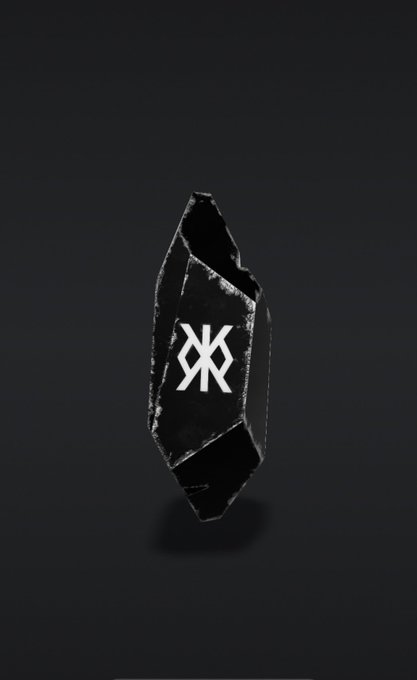 A dark, jagged black crystal-like object featuring the XRP logo etched into its center, floating against a dark background.
