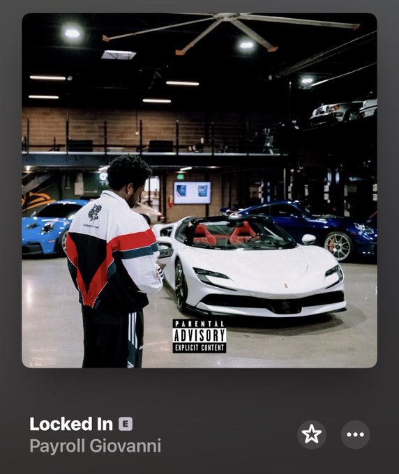 Album cover for 'Locked In' by Payroll Giovanni, featuring a man in a red, white, and black jacket standing in front of a white sports car in a garage, with a Parental Advisory Explicit Content label.