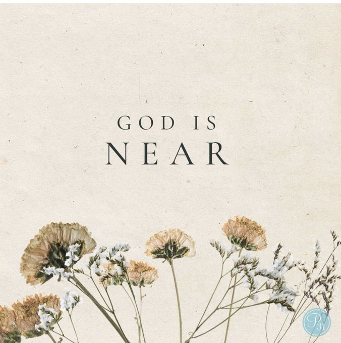 A minimalist inspirational graphic with a beige textured background, dried wildflowers at the bottom, and the centered text 'GOD IS NEAR' in elegant black lettering.