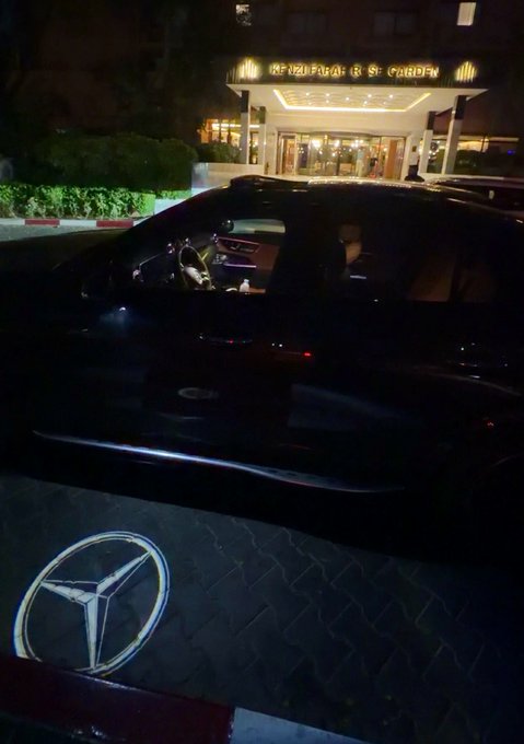 A nighttime photo shows a black Mercedes-Benz parked at the entrance of a hotel with "REGISTRATION" visible on the awning, displayed as a flex of luxury status that complements the caption's boast about success in the Web3/crypto space and offering to send SOL tokens to followers.