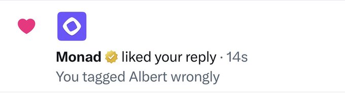 A social media notification screenshot showing that user 'Monad' with a checkmark 'liked your reply' to a comment reading 'You tagged Albert wrongly.', accompanied by a heart emoji.