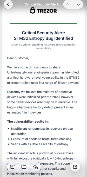 A screenshot of a phishing email disguised as a "Critical Security Alert" from Trezor, claiming a fabricated "STM32 Entropy Bug" vulnerability affecting devices with critically low "40-bit entropy." The post warns Trezor users that this is a scam attempting to steal recovery phrases, exploiting recent concerns stemming from the actual Trezor customer data breach.