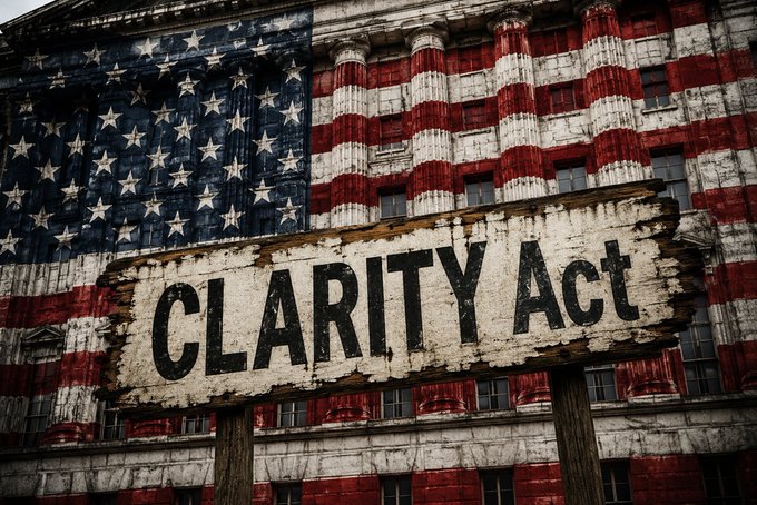 A weathered American flag painted on a building facade with a wooden sign in front reading 'CLARITY ACT'.