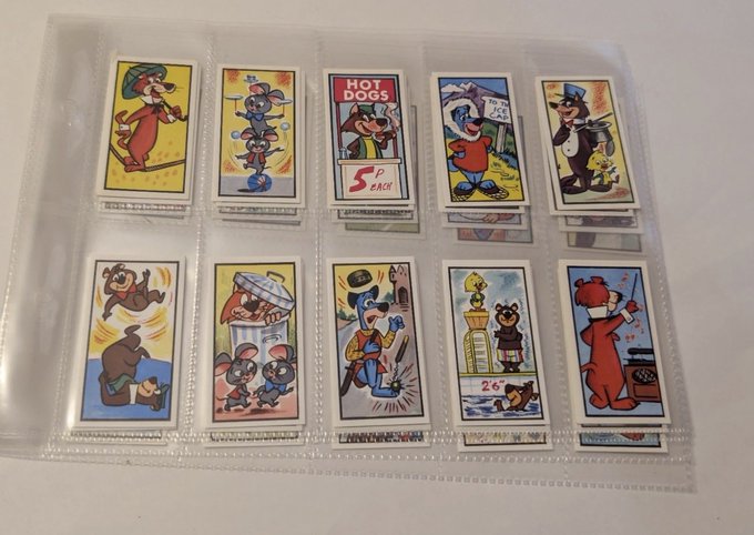 A plastic sleeve page containing ten small, vintage-style trading cards featuring colorful cartoon characters including mice, bears, and a 'HOT DOGS 5¢ EACH' sign.