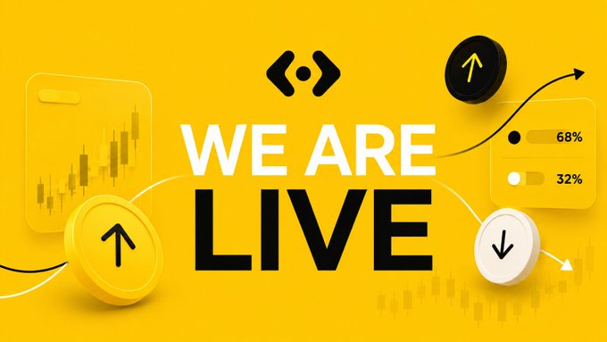 A bright yellow promotional banner with the bold text "WE ARE LIVE" surrounded by floating UI elements including candlestick charts, coins with up/down arrows, and toggle switches showing "68%" and "32%".