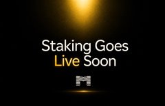 A dark promotional graphic with golden light at the top reading 'Staking Goes Live Soon' with a stylized 'M' logo at the bottom.