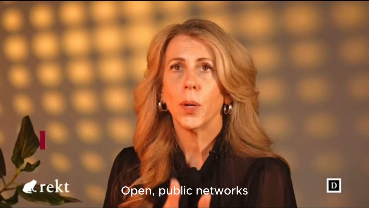 The image features an older woman with blonde hair wearing a black top, standing against a gray background. She appears to be talking or giving a speech, as indicated by her facial expression. The text "Openness = opportunity" can also be seen in the image.