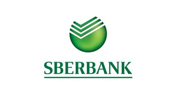 The image shows the Sberbank logo, featuring a green circular emblem with stylized geometric lines above the "SBERBANK" wordmark. This represents Russia's largest state-owned bank, which is launching Bitcoin custody services, leveraging its dominant 33% share of Russia's banking sector to build crypto infrastructure despite the country's financial isolation.