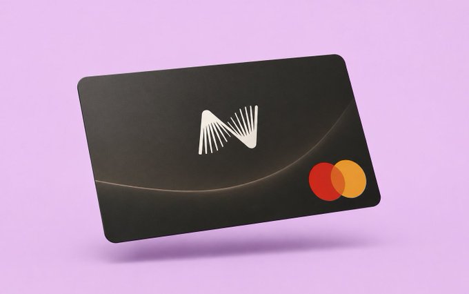 A black Mastercard-style card with a stylized white 'M' logo featuring sunburst lines, displayed against a light purple background.