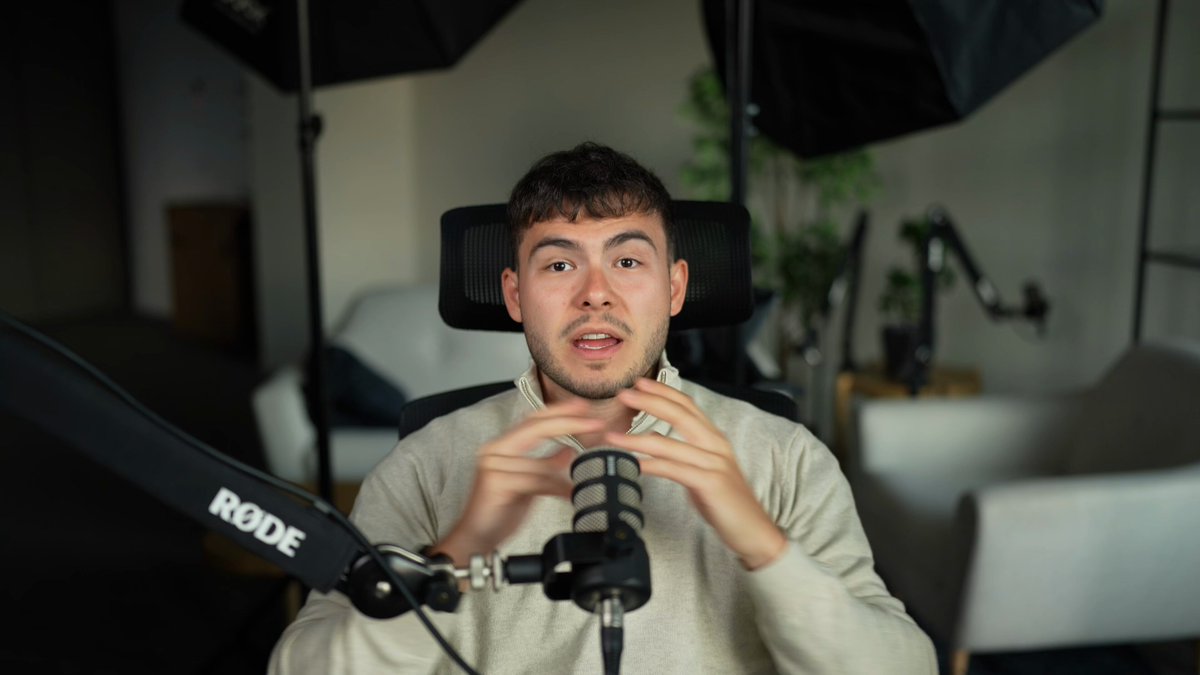 The image features a man sitting in front of a microphone, holding it up to his face as if he's about to speak into it. The background shows an office setting with chairs and potted plants scattered around. There are two umbrellas visible in the scene, one on the left side and another on the right side. A caption below the image reads: "Edel is moving beyond lending rails for tokenized stocks. The next step is full infrastructure for onchain equities. Vaults, listings, and more users come next week. So does the first look at what Edel is becoming."
