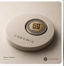 A round, beige "CHROMIA" branded sleep tracker device displays "99" with a graph icon on its screen, accompanied by Nomisma branding at the bottom. The image showcases the on-device AI technology powering Sleepagotchi's sleep optimization, which the post highlights as a key component of its intelligence layer beyond typical DeFi activity.