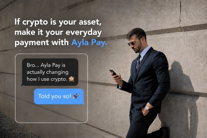 A promotional advertisement for Ayla Pay showing a man in a suit checking his phone against a concrete wall, with the headline 'If crypto is your asset, make it your everyday payment with Ayla Pay' alongside a chat exchange reading 'Bro... Ayla Pay is actually changing how I use crypto' and 'Told you so!'.