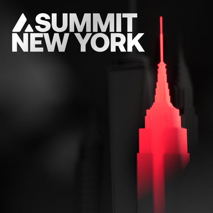 The image features a large red skyscraper with a white base, which stands out against a black background. The skyscraper appears to be lit up, possibly at night or during an event. The caption of the image reads "Avalanche Summit comes home to New York. Where markets move. Where capital flows. Where institutions operate at the highest level. Where culture, finance, and technology shape what comes next. This is where Summit belongs. And so do you."
