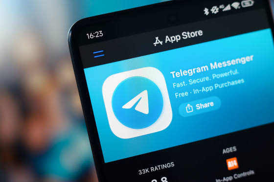A smartphone screen displaying the Telegram Messenger app on the App Store, with the tagline 'Fast. Secure. Powerful. Free · In-App Purchases' and 33K ratings.