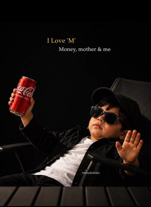 A young child dressed in a black cap, sunglasses, and dark jacket lounges in a chair holding up a can of Coca-Cola against a dark background, with the text "I Love 'M' - Money, mother & me" displayed above, projecting a humorous "alpha" or boss-like persona.