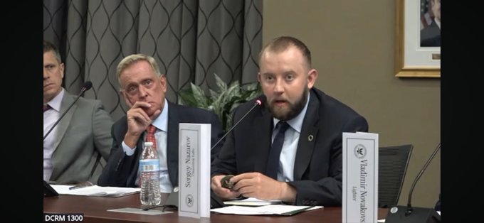 Two men sit at a congressional hearing panel, with Sergey Nazarov's name placard visible, while the man on the right appears to be speaking into a microphone during what seems to be testimony before the U.S. House Committee on Financial Services. The setting suggests this is a formal government proceeding, possibly connected to discussions about digital assets or blockchain technology that Nazarov, as a key figure in the cryptocurrency space, would be involved in.